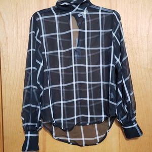 See through black and white plad top.